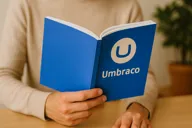 Image or a person holding an Umbraco manual
